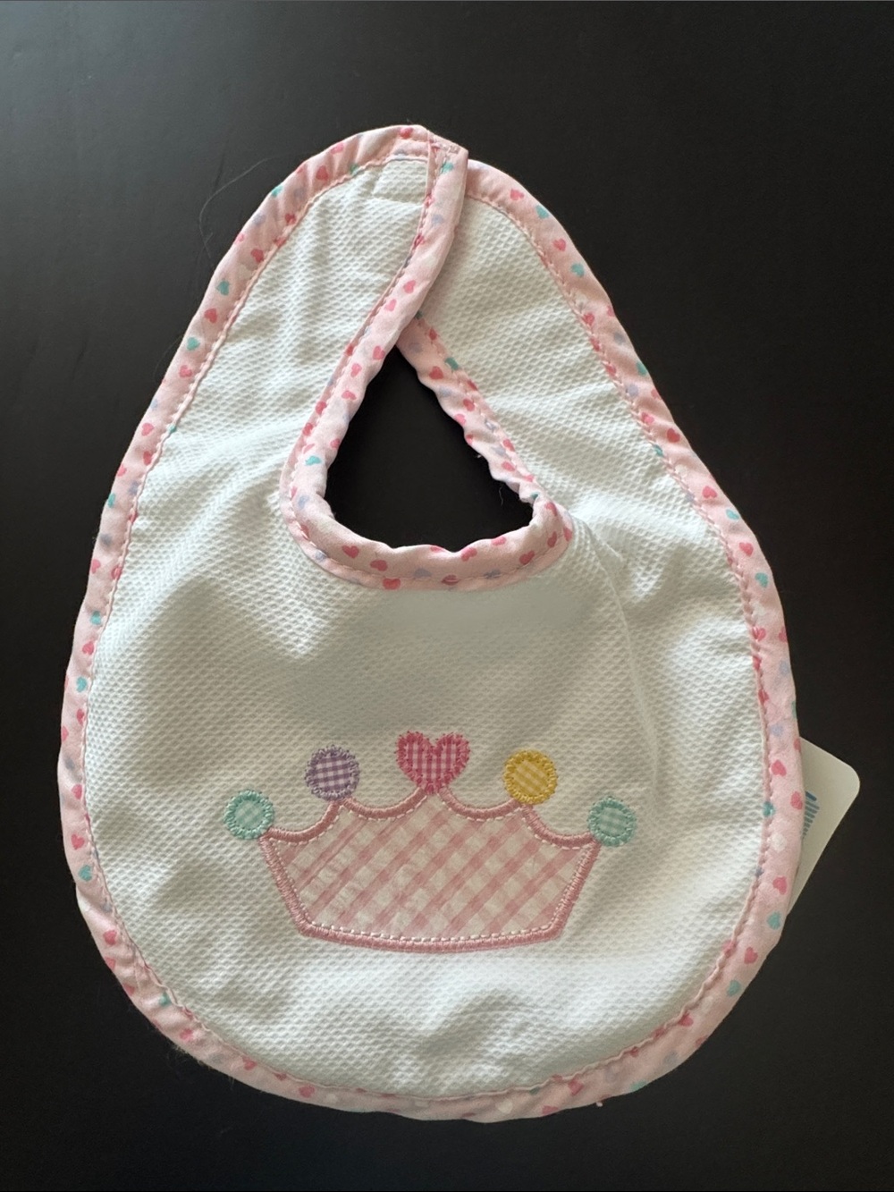 White Bib with Pink Trim and Pastel Crown Applique